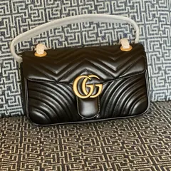 Seller photograph of a black small Gucci GG Marmont, listed new with tags