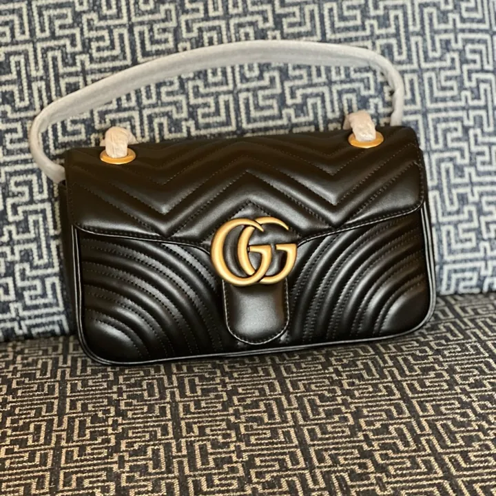 Seller photograph of a black small Gucci GG Marmont, listed new with tags