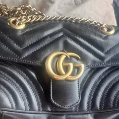 Seller photograph of the same-model pre-owned black small Gucci GG Marmont. $800 less than the new listing