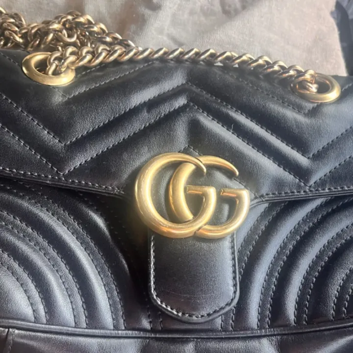 Seller photograph of the same-model pre-owned black small Gucci GG Marmont